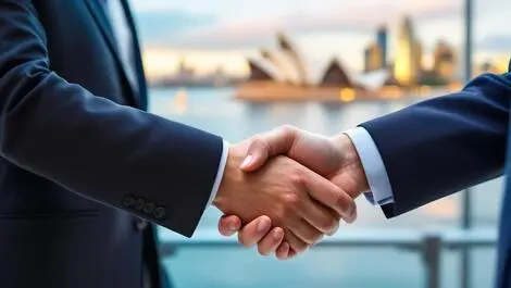 Handshake between businesspeople formal attire sydney opera house melbourne skyline background